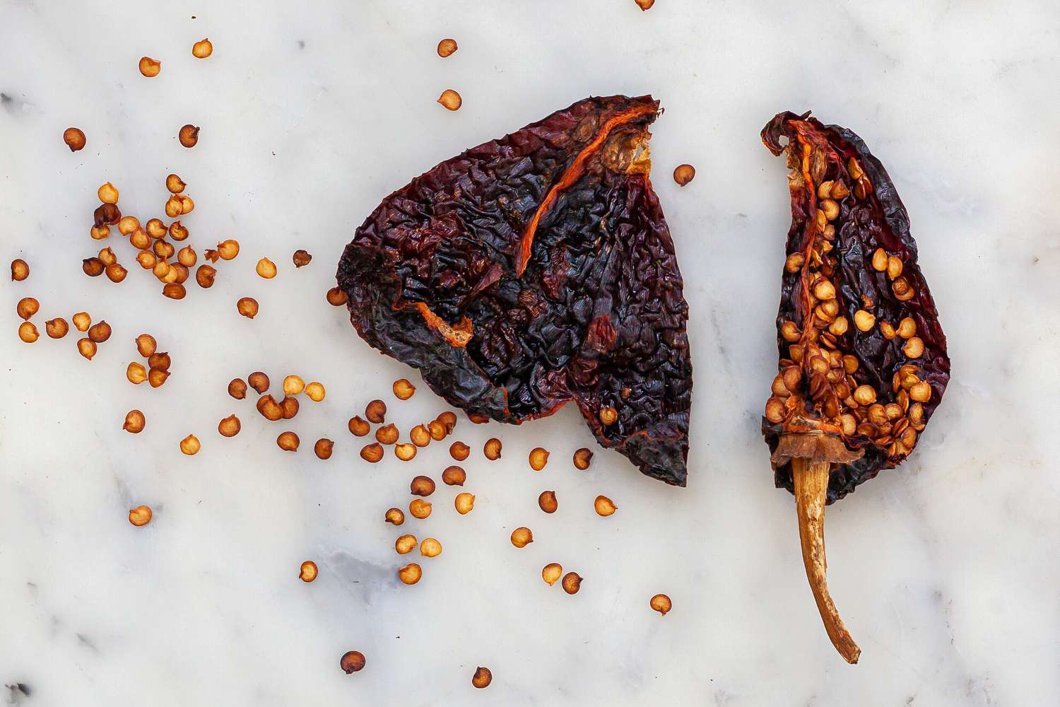 A red chili sliced with the sides scattered around.