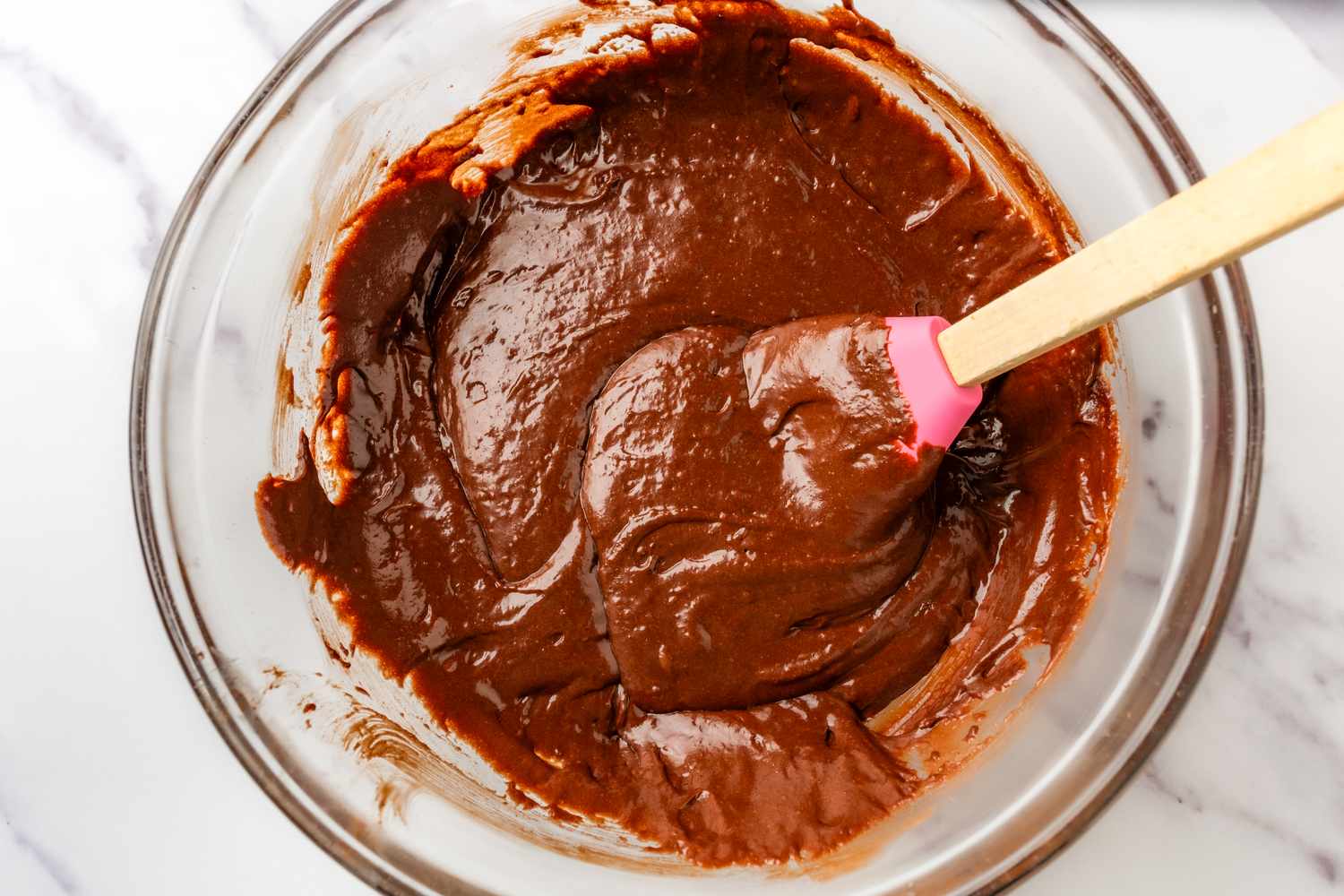 Overhead view of a large mixing bowl after adding the wet ingredients to the batter for Never-Fail Chocolate Cake recipe