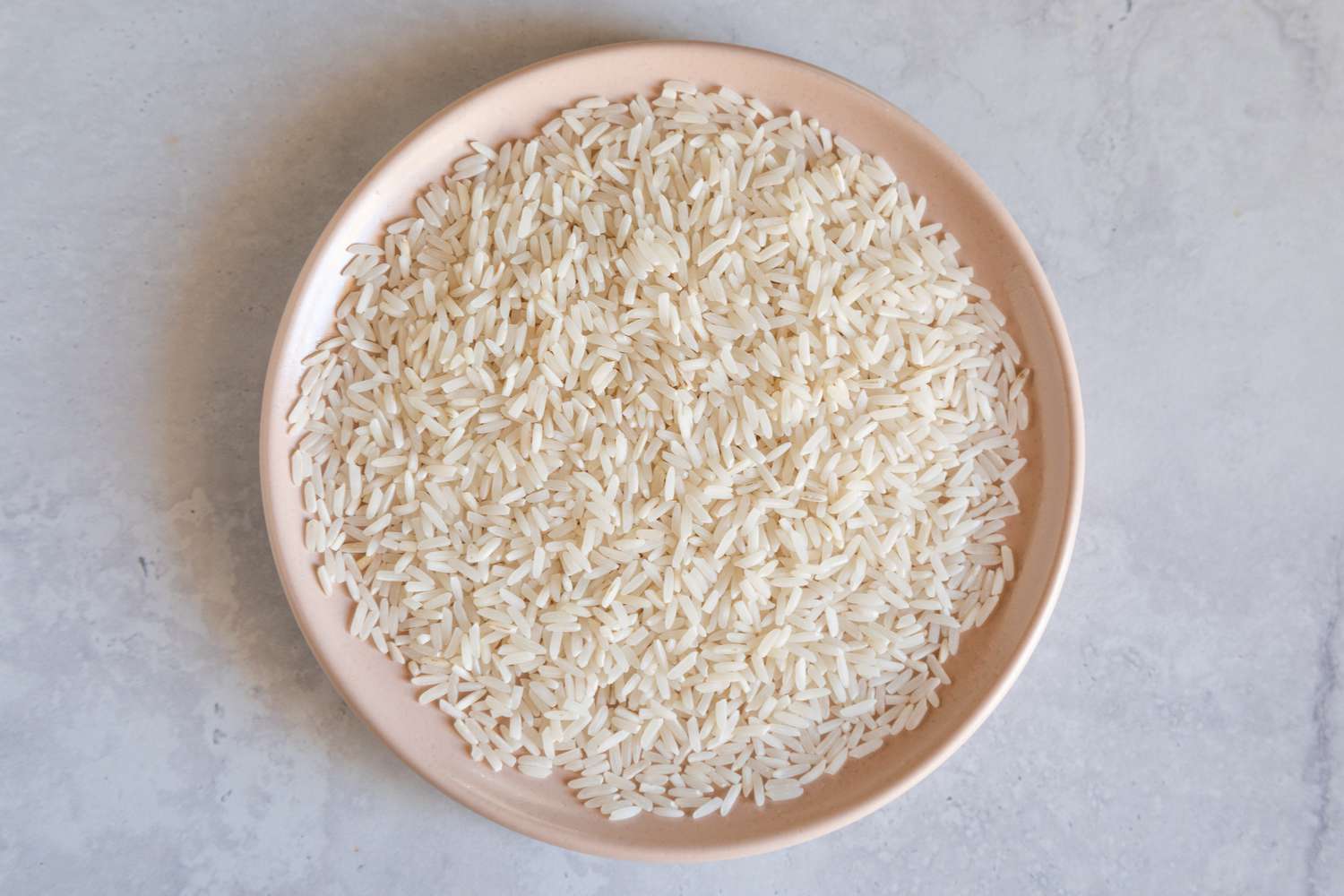 Long grain white rice on a peach plate