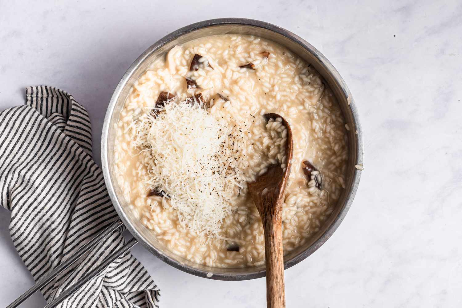 Adding cheese to a cooking risotto 