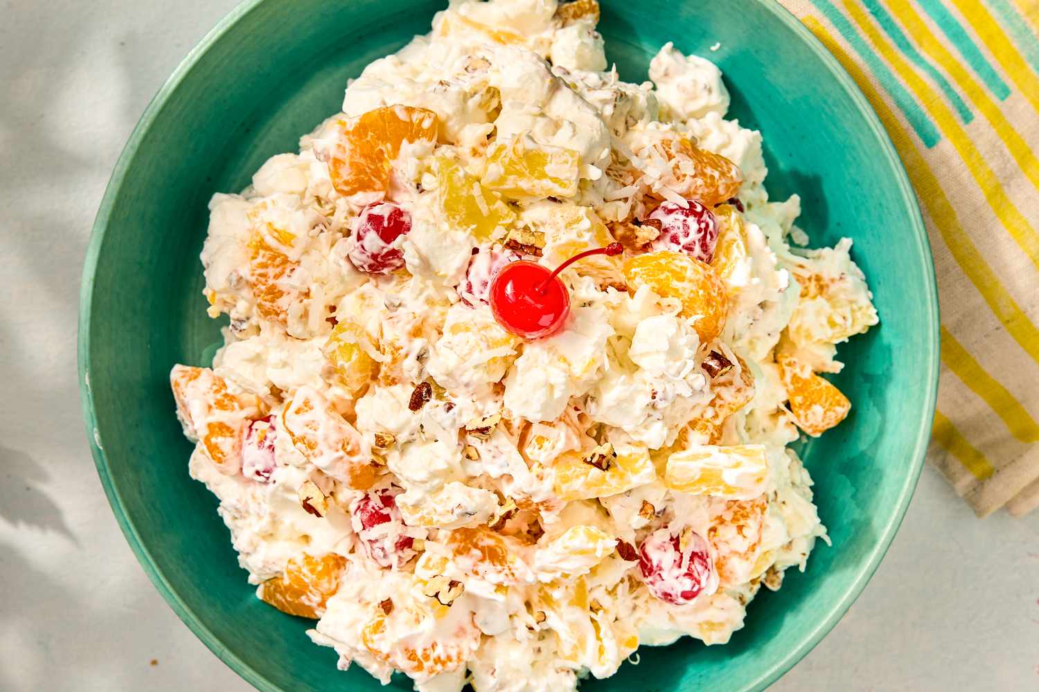 Bowl of ambrosia salad with fruit and marshmallows