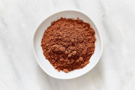 A bowl containing cocoa powder viewed from above