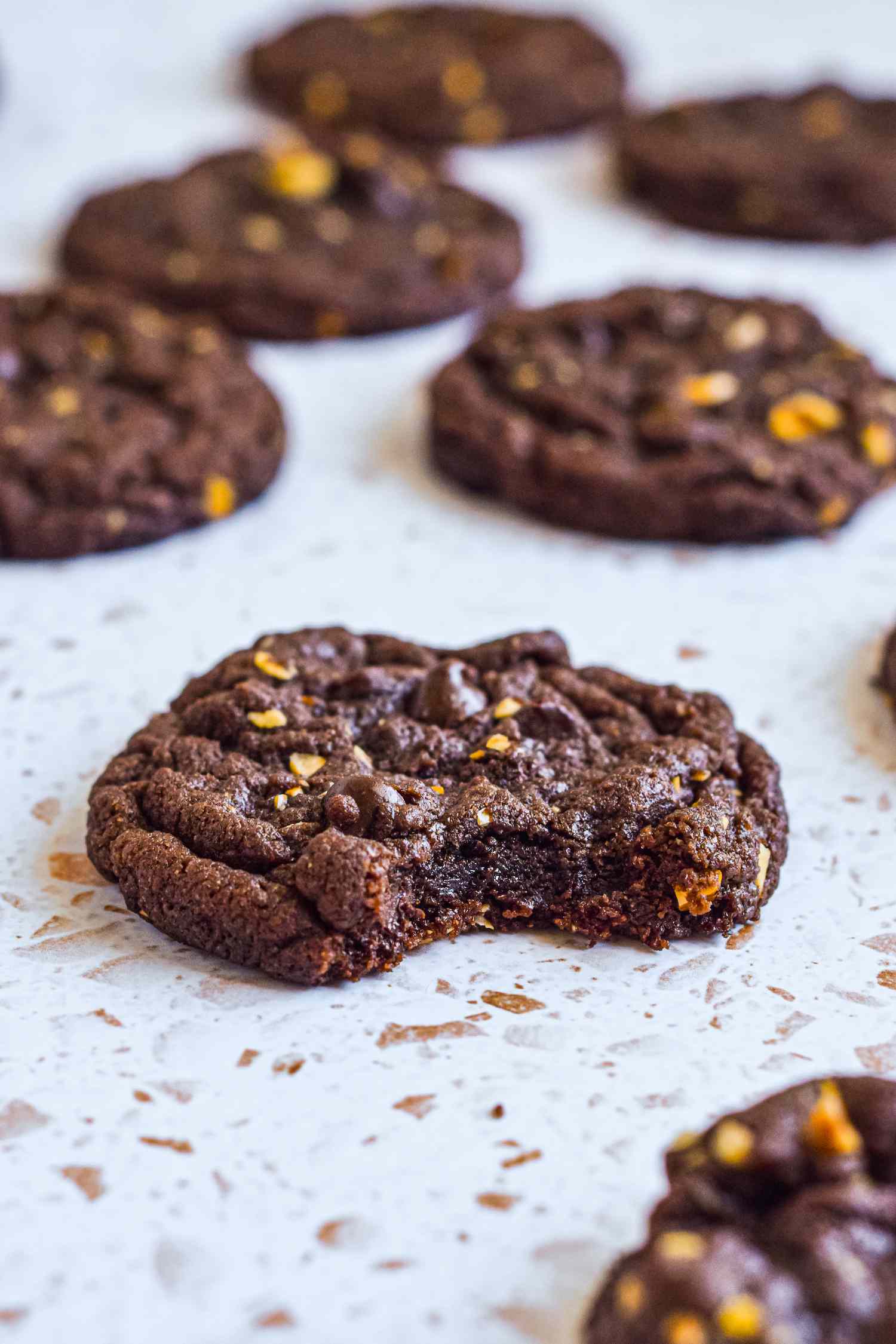 Chocolate nutella cookies on a speckled surface.