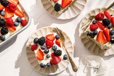 slices of Easy Berry Chantilly Cake on small plates with forks