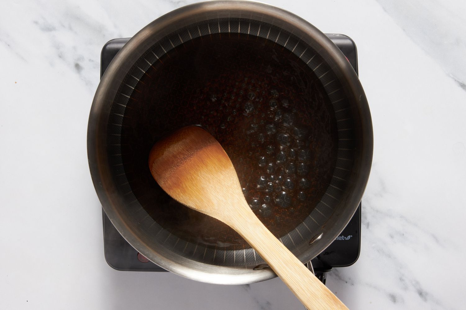 Dr. Pepper boiling in a saucepan for Dr. Pepper cake recipe