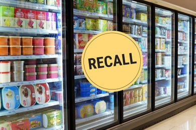 Frozen food section of a grocery store with a recall sign overlayed