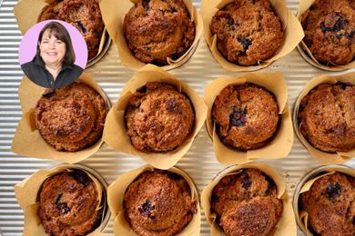 Ina Garten next to a tray of muffins in paper wrappers