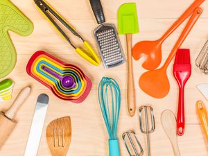 Overhead view of various kitchen gadgets and tools on a wooden tabletop