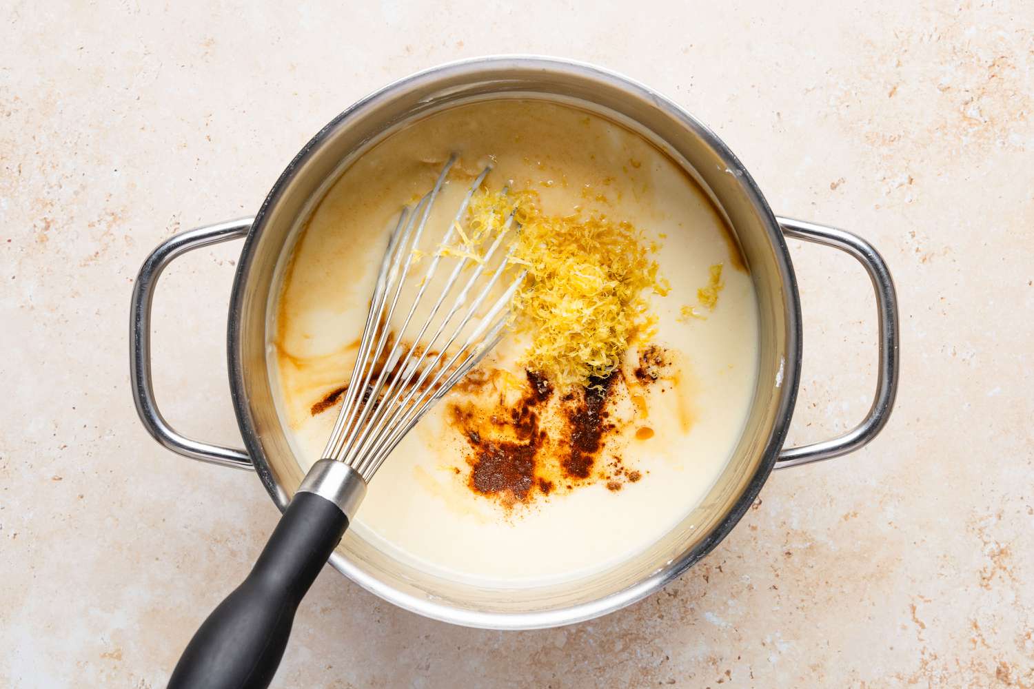 lemon zest, cinnamon added to pot with a whisk for Migliaccio (Italian Ricotta and Semolina Cake)