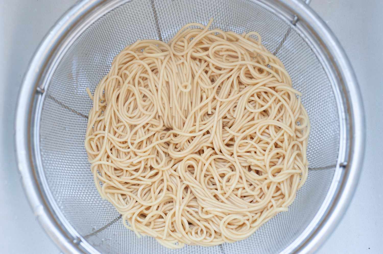 Noodles draining in a colander.