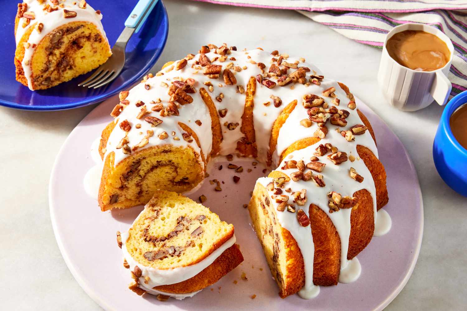 Sock it to me cake on a plate with a few slices cut out and on small plates in the surrounding 