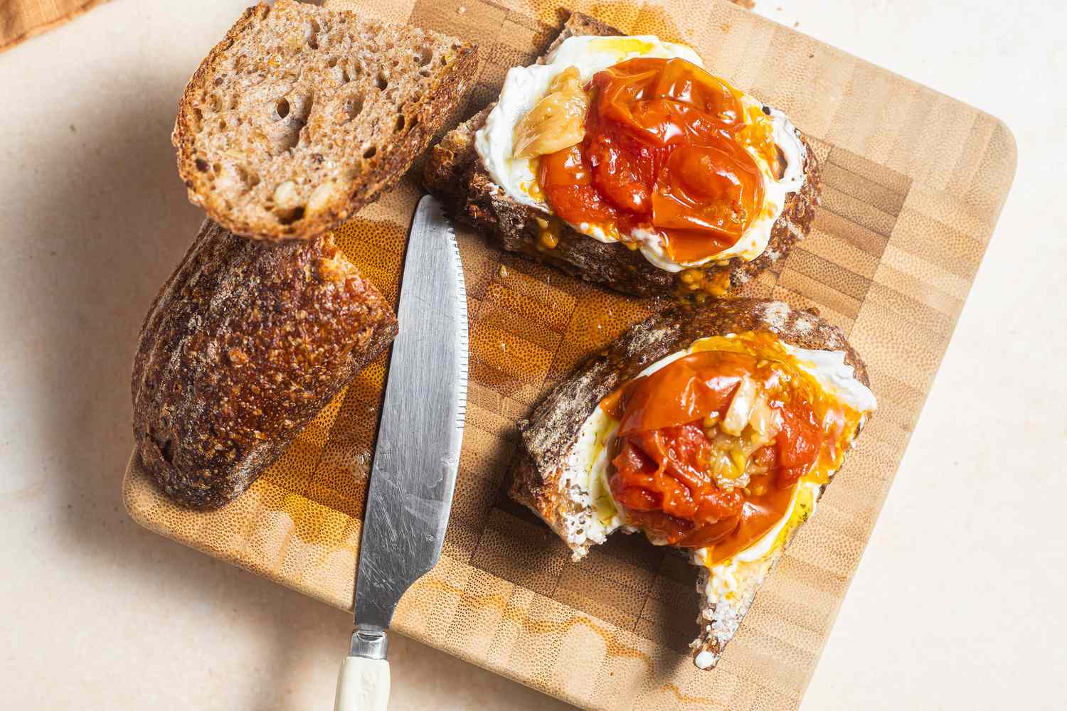 Tomato Confit Spread on Toast on a Cutting Board 