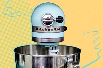 KitchenAid stand mixer over a yellow illustrated background