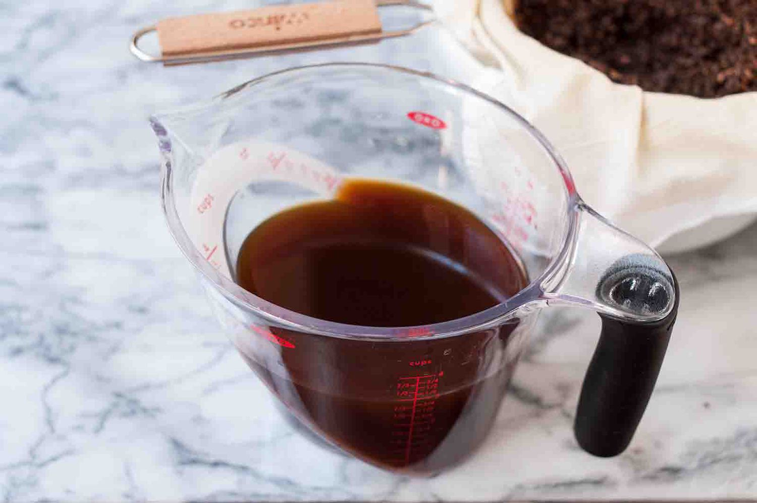 A measuring cup with strained cold brew coffee 