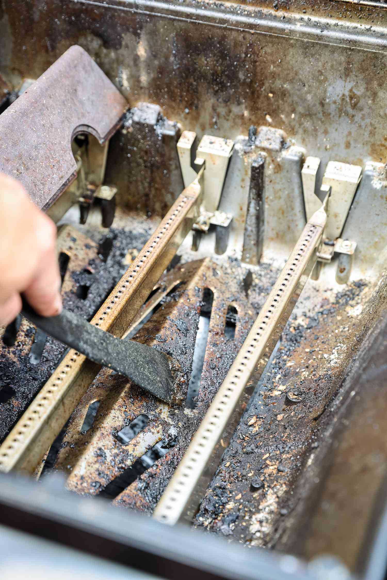 Gas Grill Burners Scraped and Cleaned