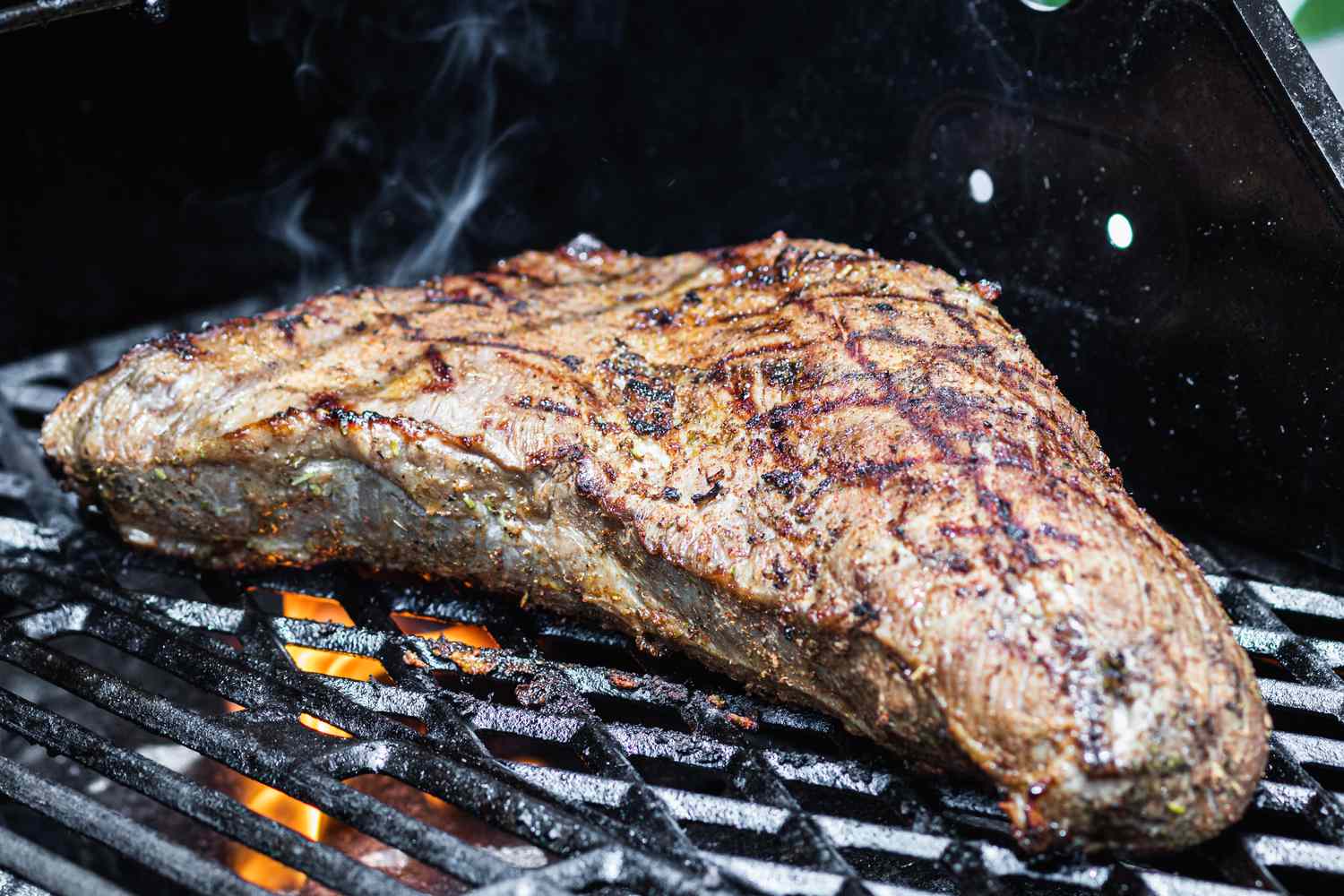 A Santa Maria tri tip cooking on the grill.