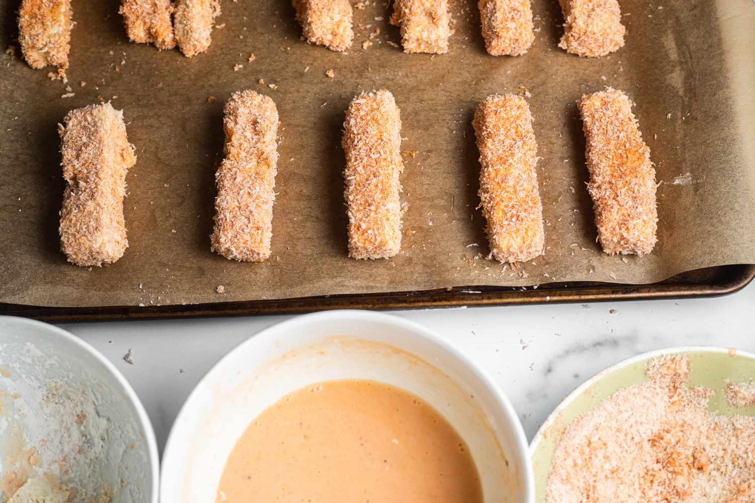 Sheet Pan Buffalo Tofu Breaded and Sitting on Baking Pan