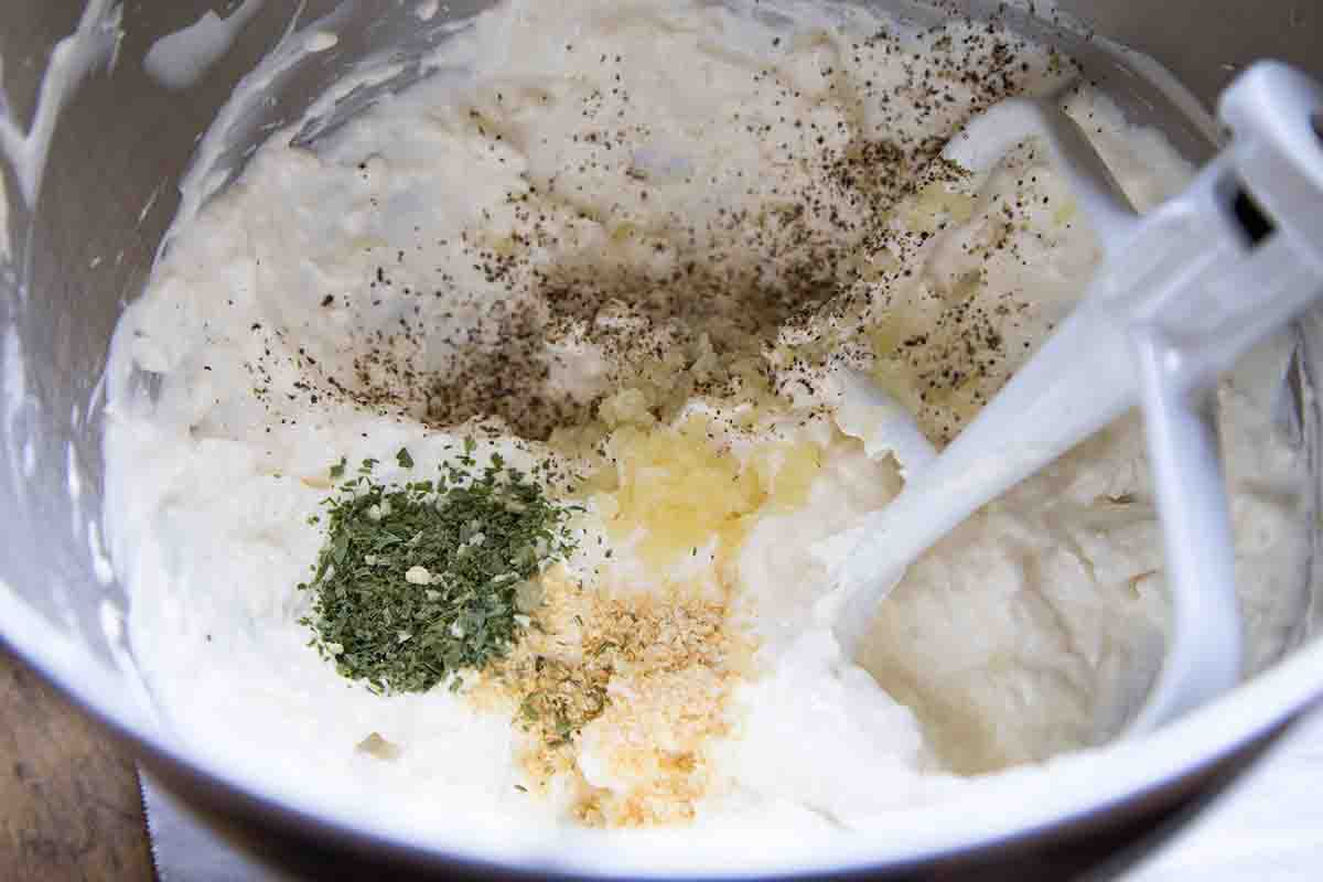 Beat together the cream cheese, sour cream, and mayo for the buffalo chicken dip