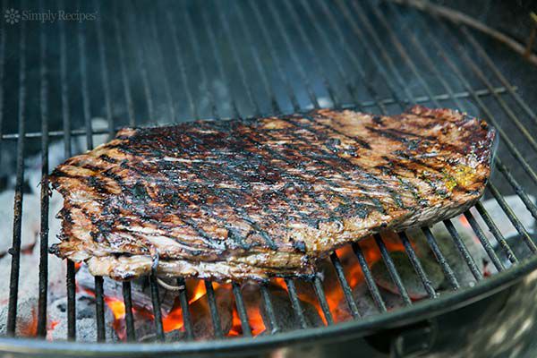 perfectly grilled flank steak on coal grill