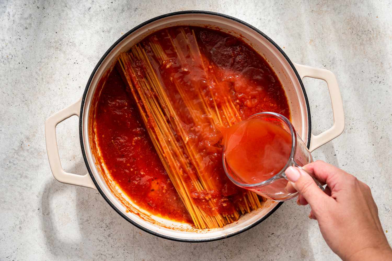 Tomato broth added to pot, little by little, until slightly covered for assassin's spaghetti recipe