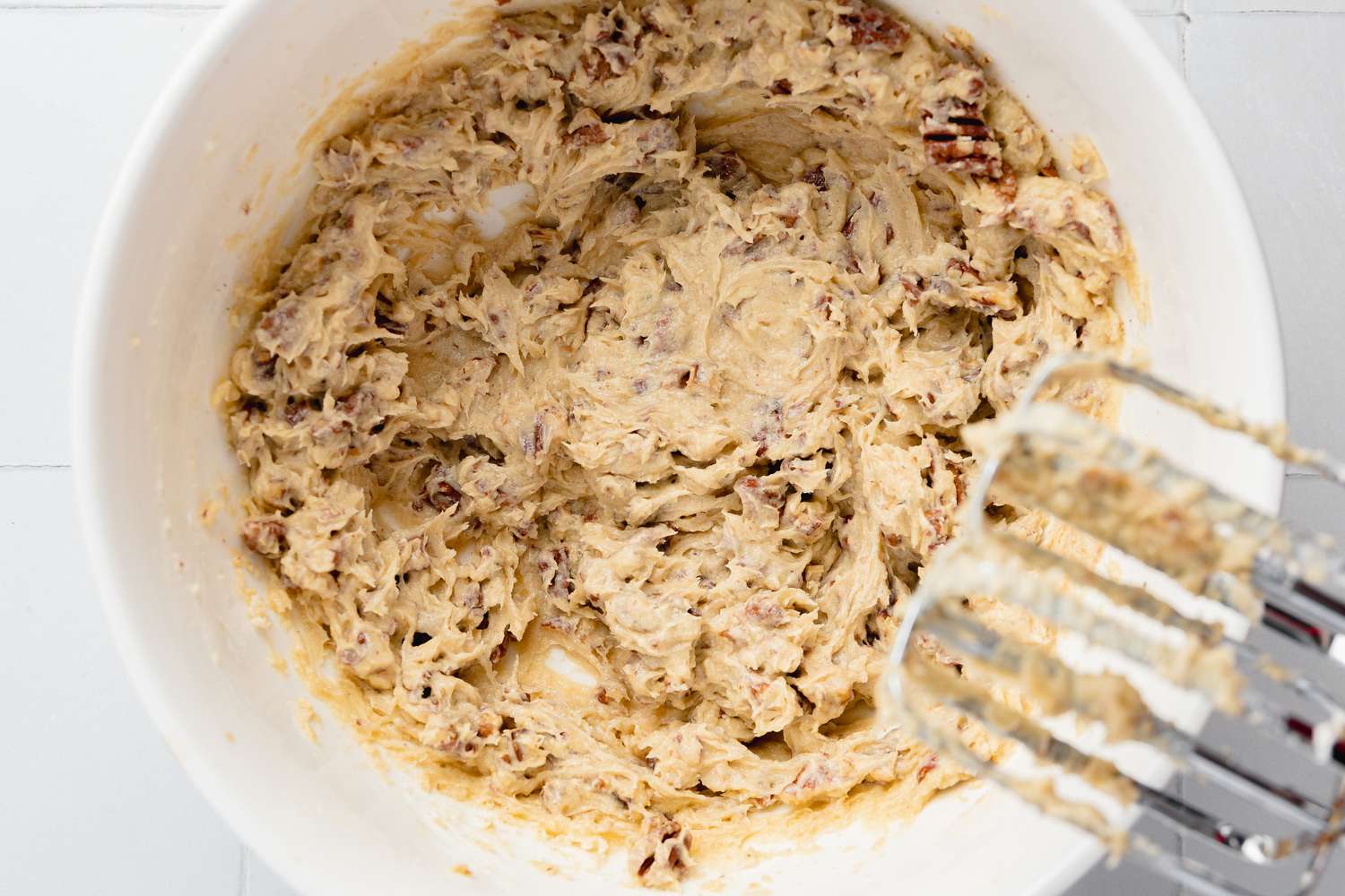Pecans Whisked into Bowl of Wet Ingredients for Turtle Cookie Cup
