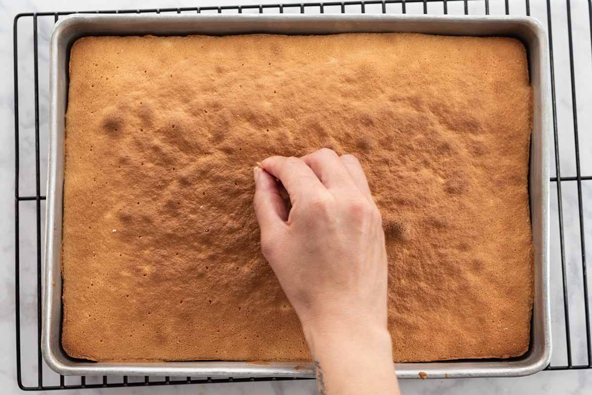 Mexican Tres Leches Cake poke holes into the cake with a toothpick