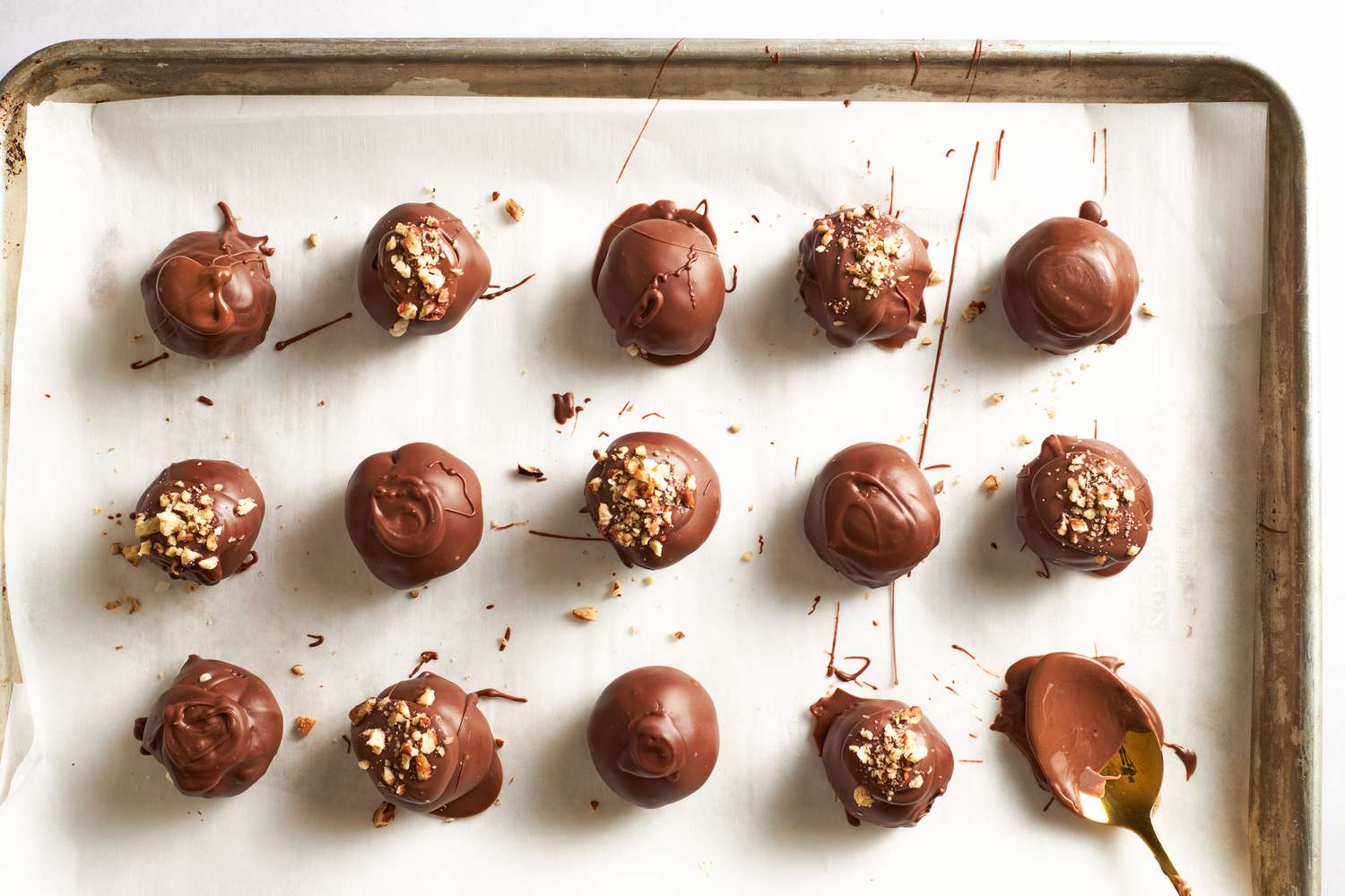 Martha Washington Candy on a parchment covered sheet pan, some topped with nuts