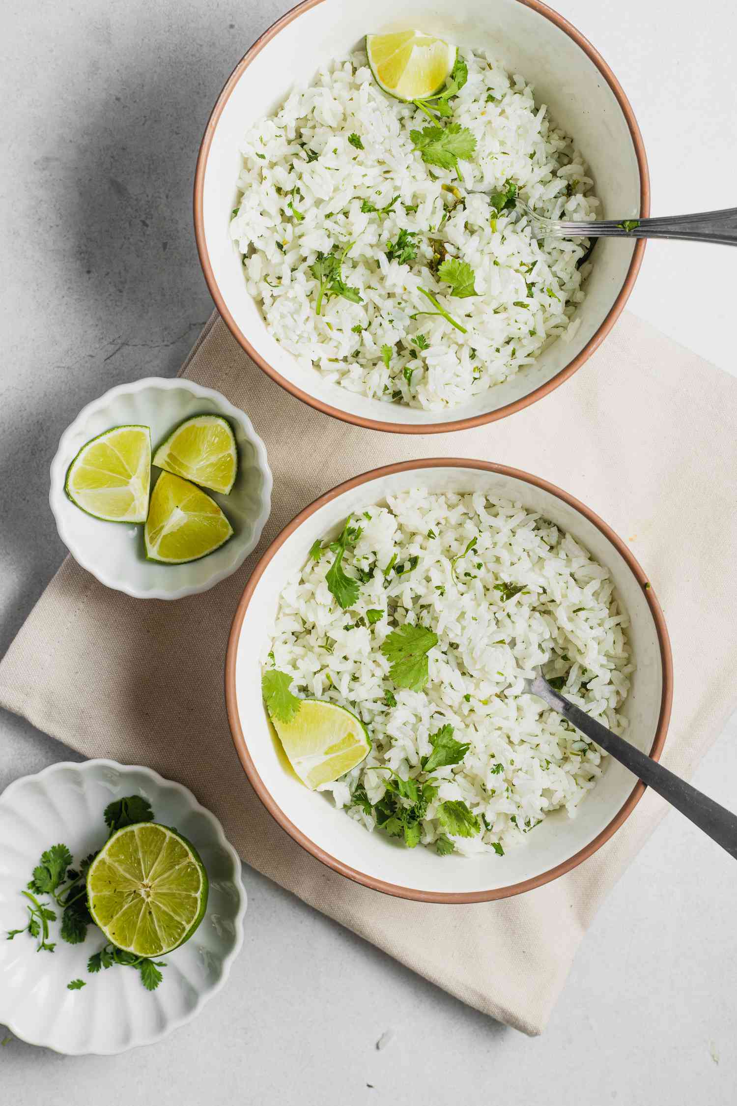 Bowls of Coconut Lime Rice with Lime Wedges and a Small Bowl with Lime Wedges