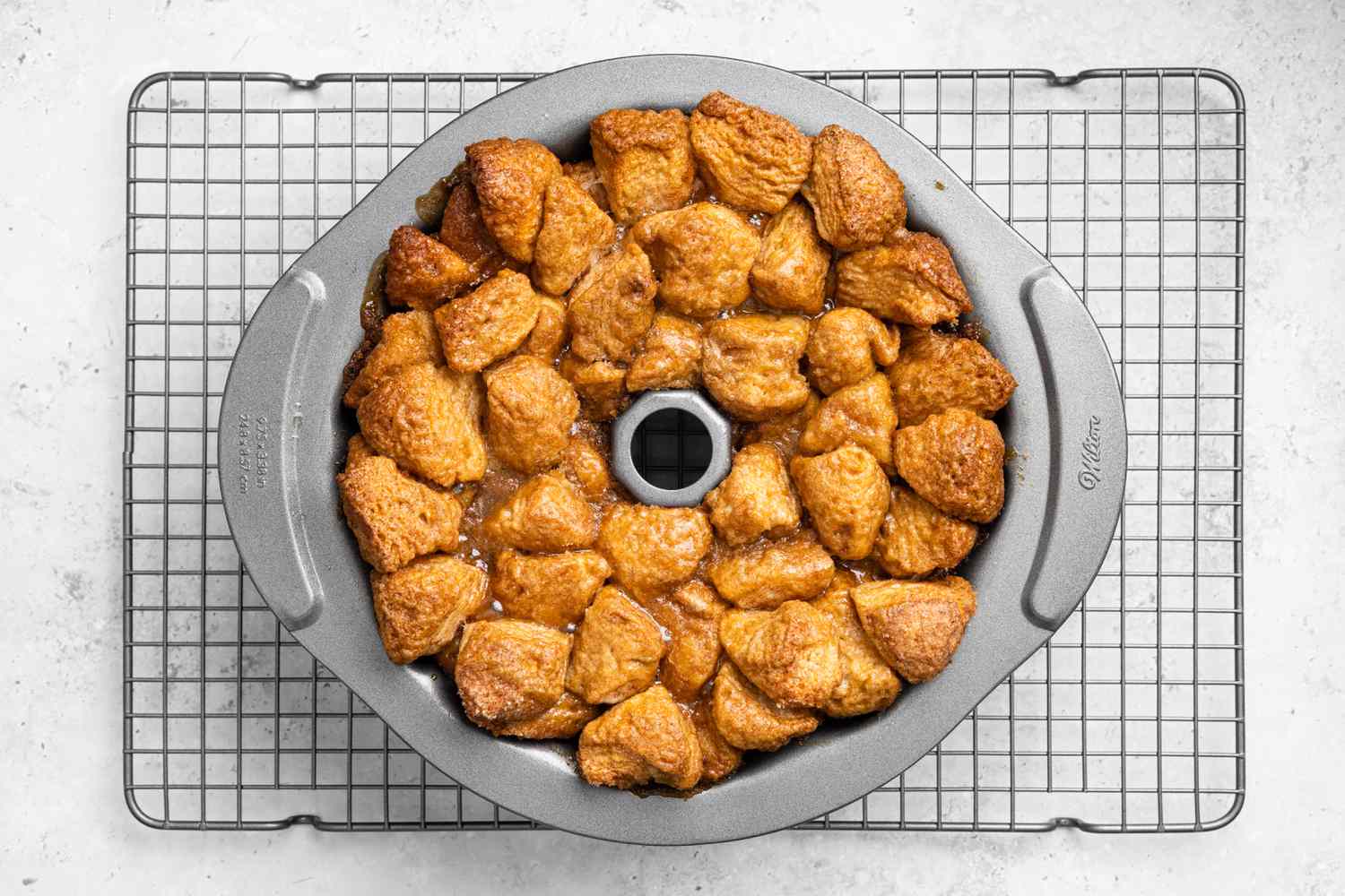Baked Monkey Bread in Bundt Pan Resting on Cooling Rack