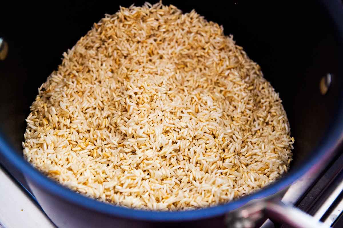 Brown rice in a sauce blue pan
