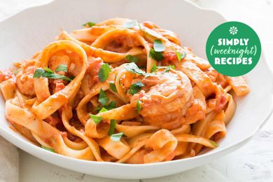 A bowl of pasta with shrimp in a creamy sauce labeled as a Simply Weeknight Recipe