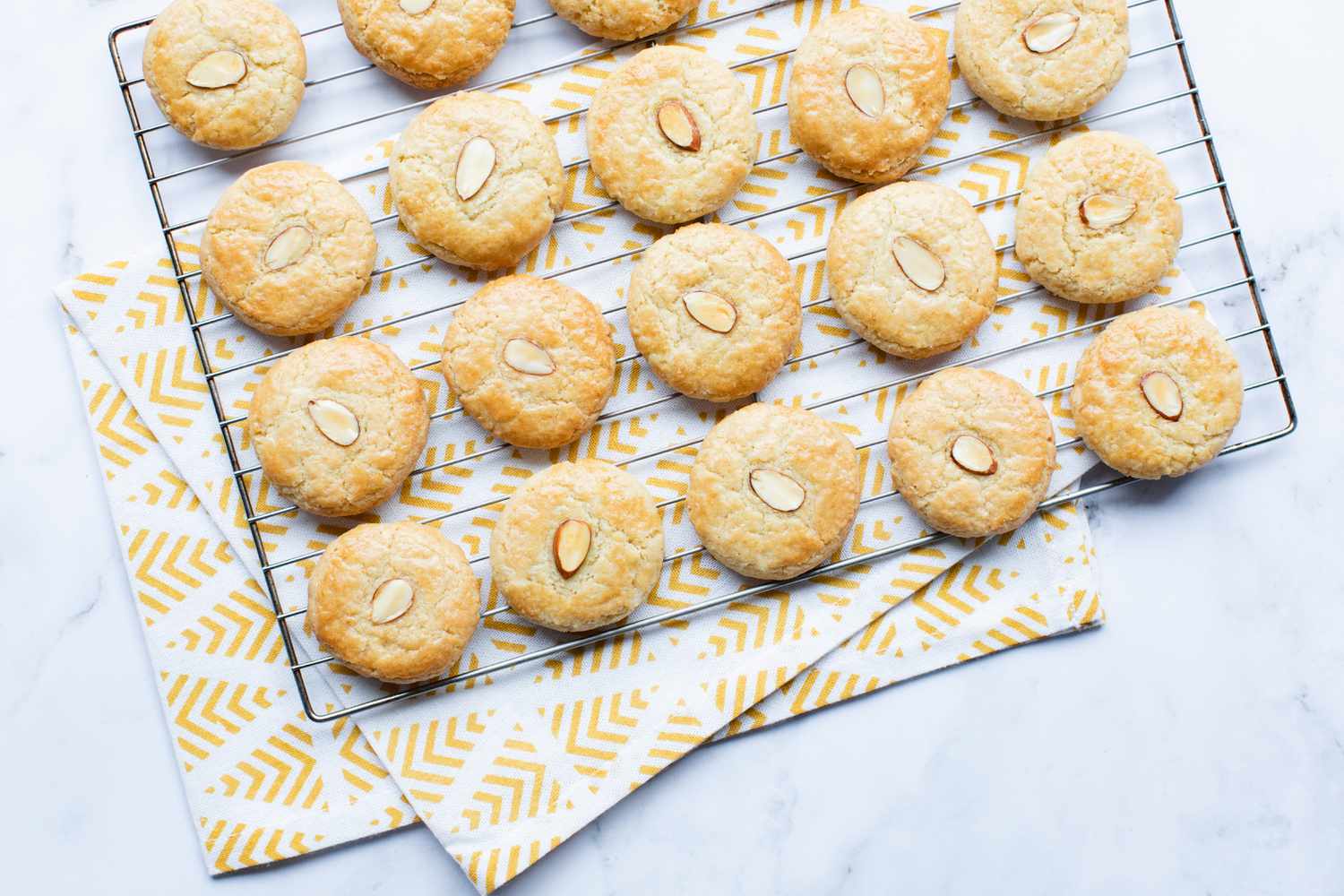 Overhead view of almond cookies on a cooling tray.
