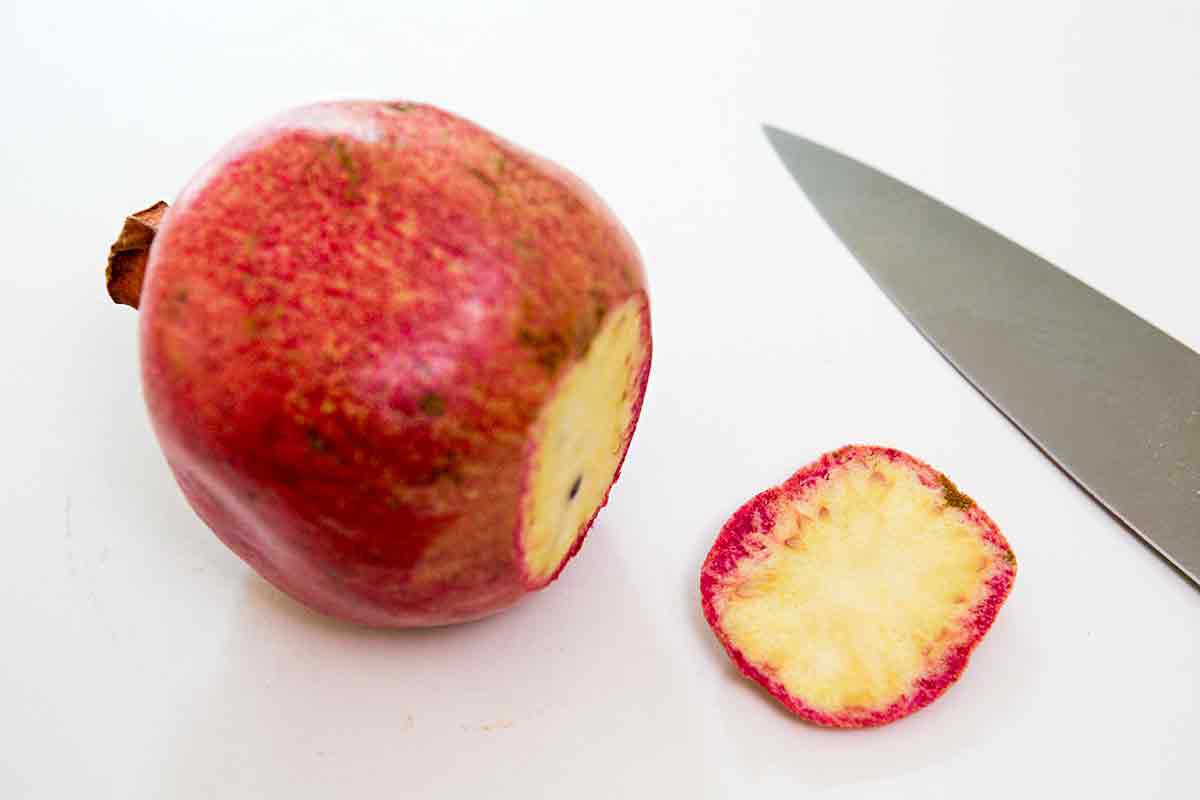 how to cut a pomegranate - step 1 slice off bottom