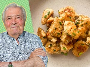 Jacques Ppin pictured beside a dish of cooked chicken pieces