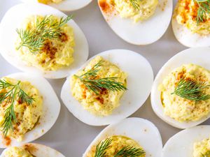 How to Make Deviled Eggs -- Close up of deviled eggs with dill and paprika