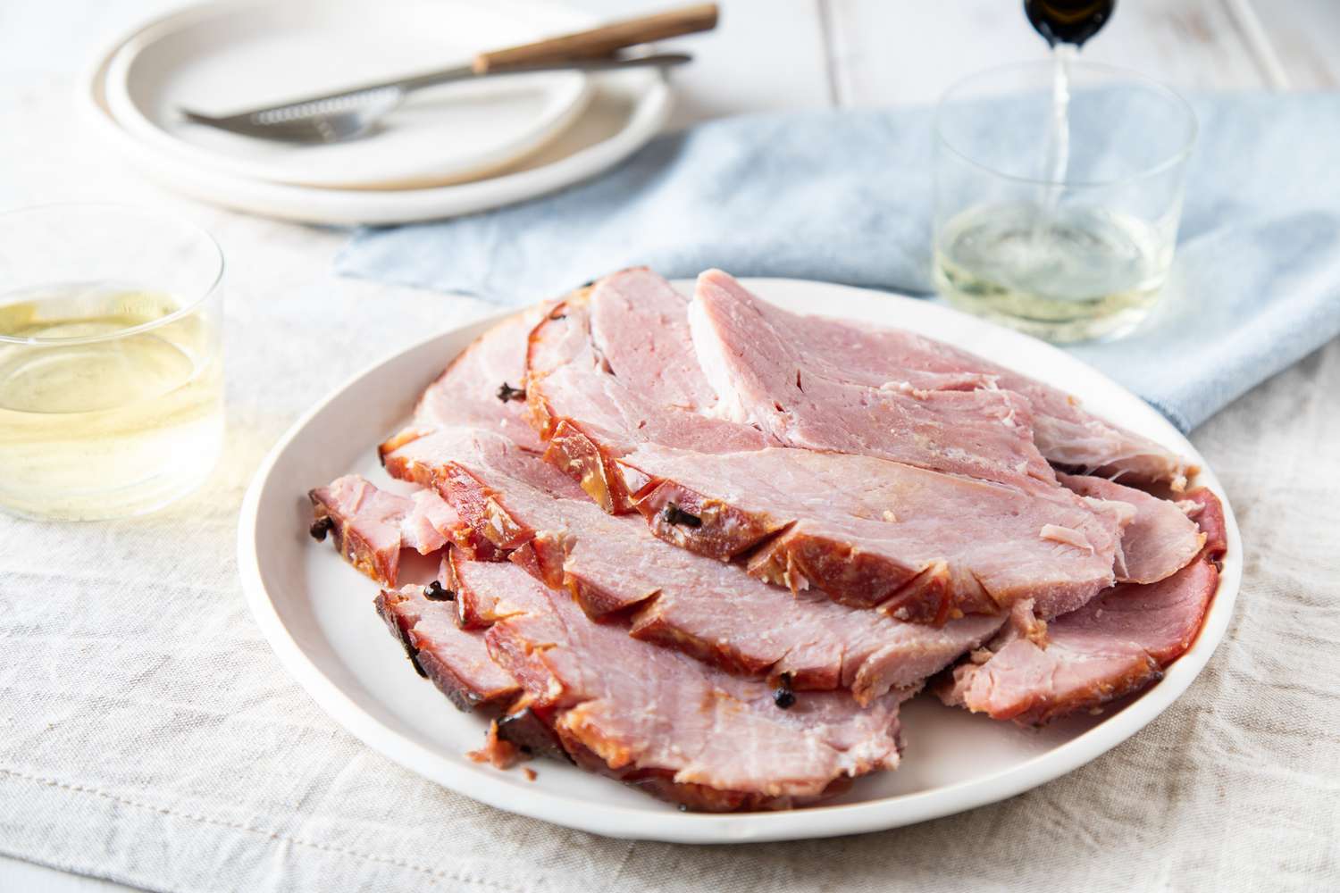 Slices of cooking ham on a plate.