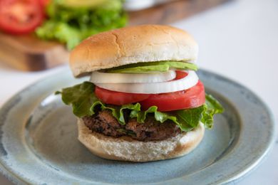 Side view of a hamburger with toppings.