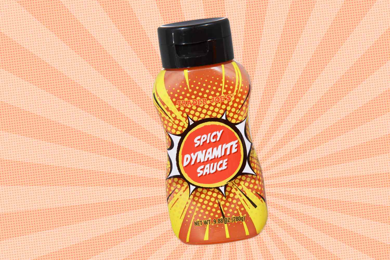 Bottle of spicy dynamite sauce on a patterned background