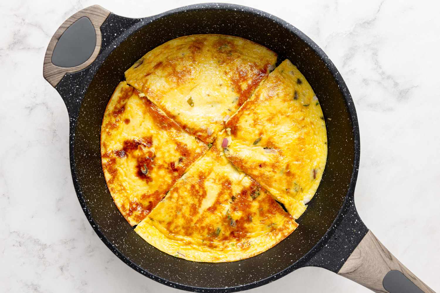 Spicy Coconut Ginger Omelette in Pan Cut into Four Slices