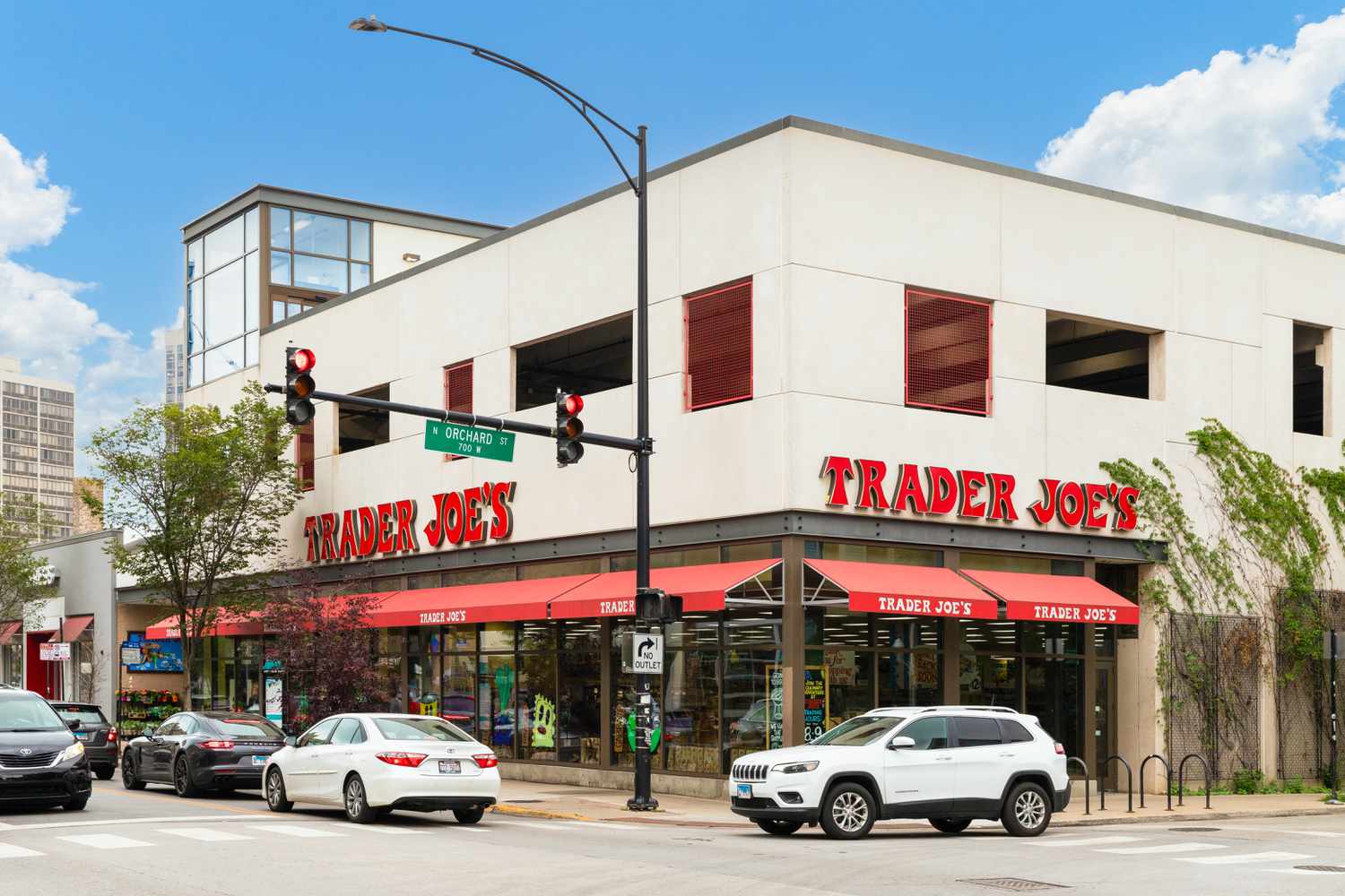 trader joe's storefront on the corner of a busy street