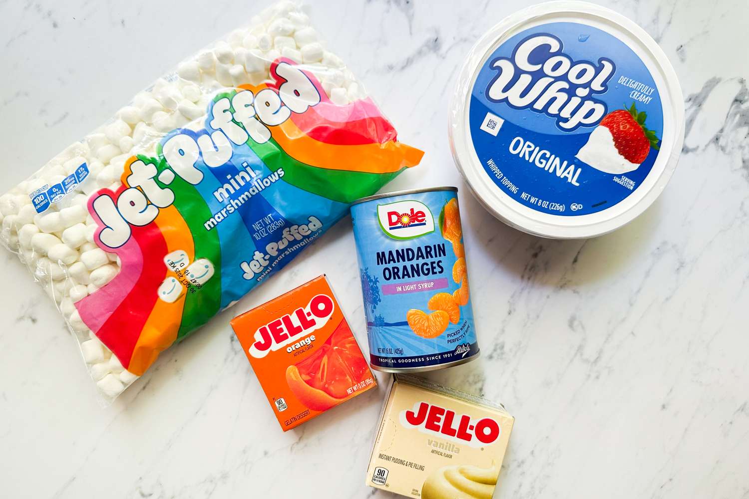 Ingredients for a dessert mini marshmallows orange gelatin vanilla pudding mix canned mandarin oranges and whipped topping