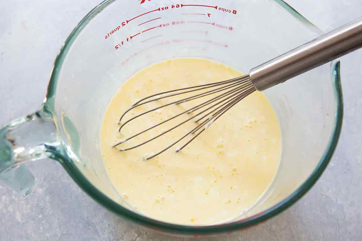 Tomato quiche beat the eggs with cream, sour cream, and milk