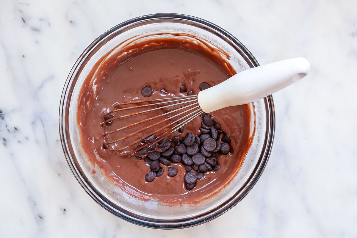 Chocolate chips added to a chocolate mixture to make a chocolate pudding recipe.