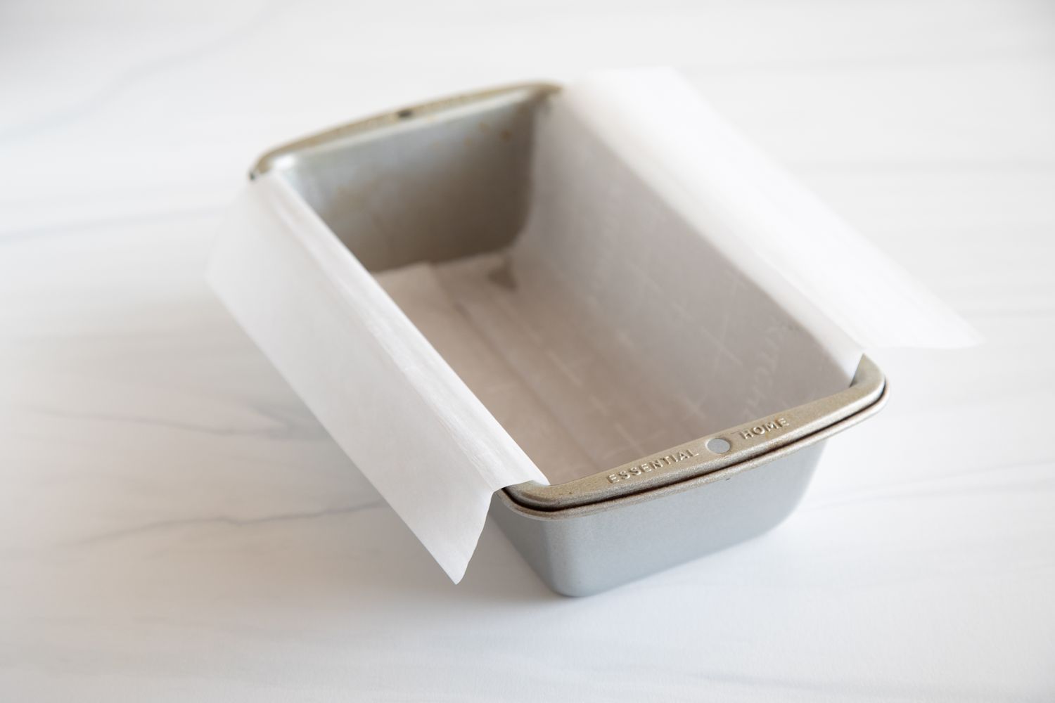 A loaf pan covered in parchment for s Simple Yogurt Cake