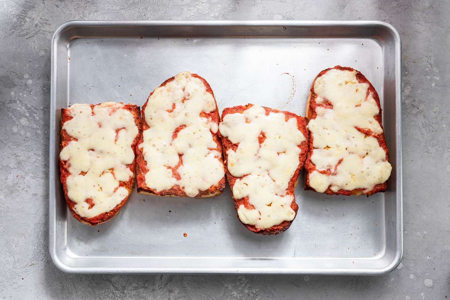 French Bread Pizza on the Baking Sheet After Baked (Cheese Is Melted)