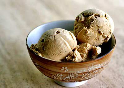 Two scoops of coffee ice cream in a patterned bowl