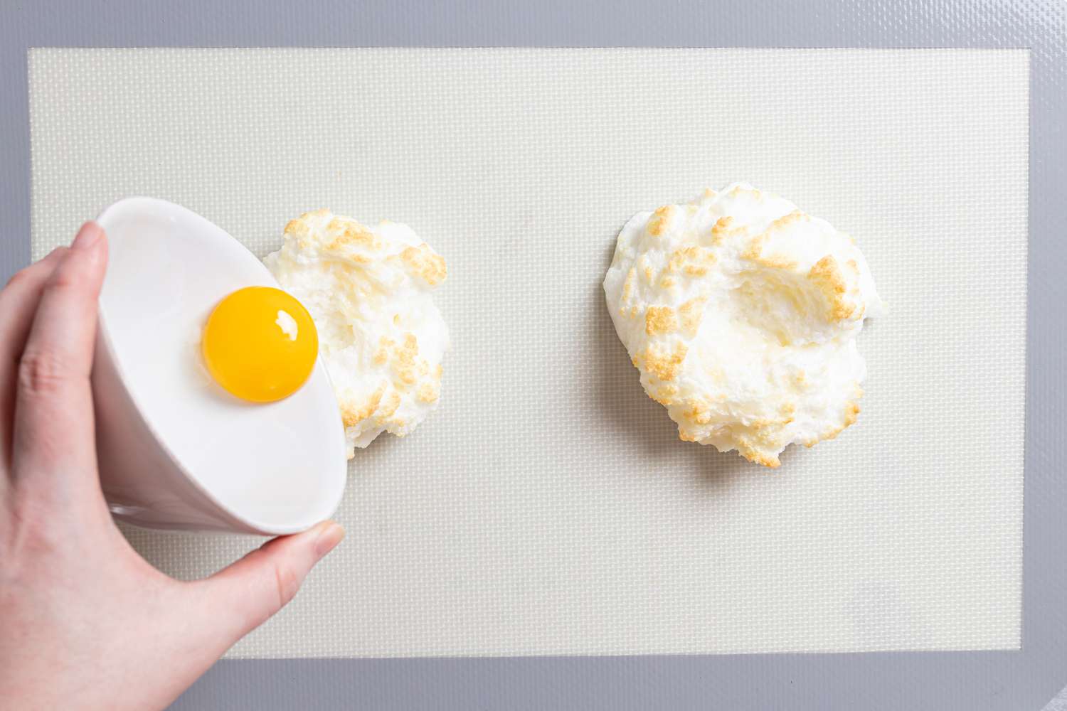 How to make Cloud Eggs by sliding an egg yolk into a mound of beaten egg white