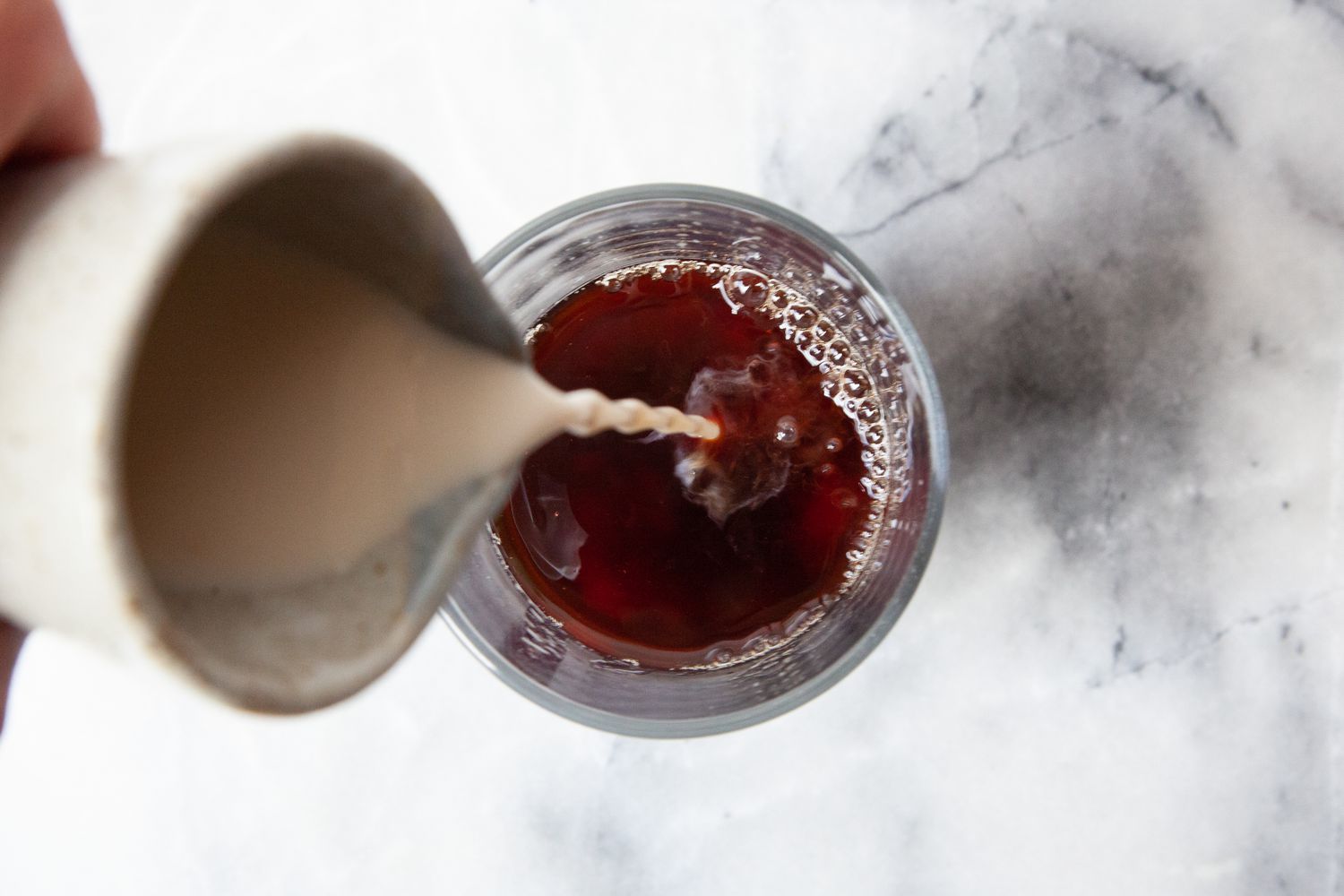 Milk Poured Into Glass With Tapioca Pearls and Black Tea