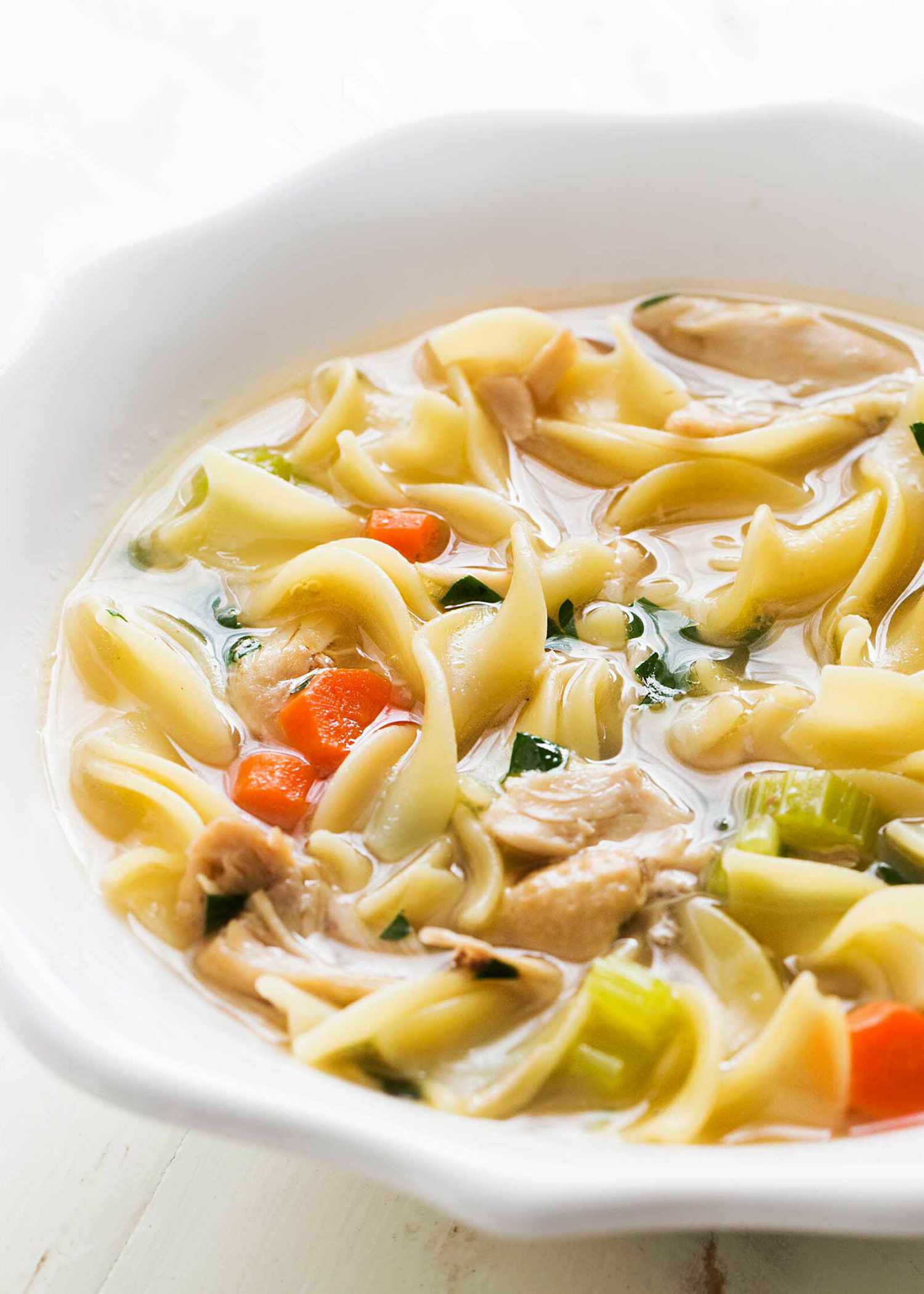 Easy chicken noodle soup in a white bowl.