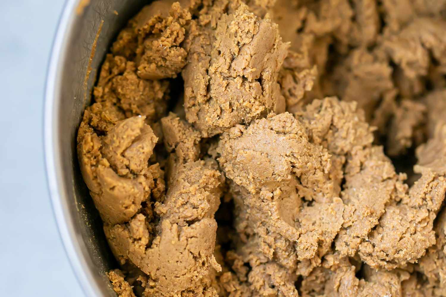 Dough for a gingerbread recipe in a metal bowl.